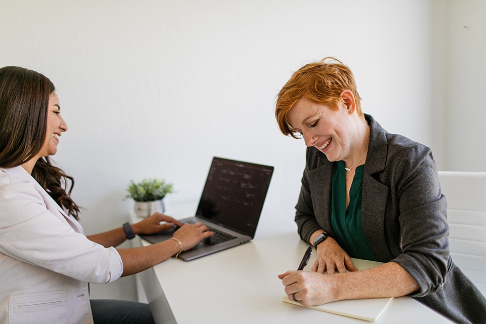 ONE Home Better Way Two women meeting at desk