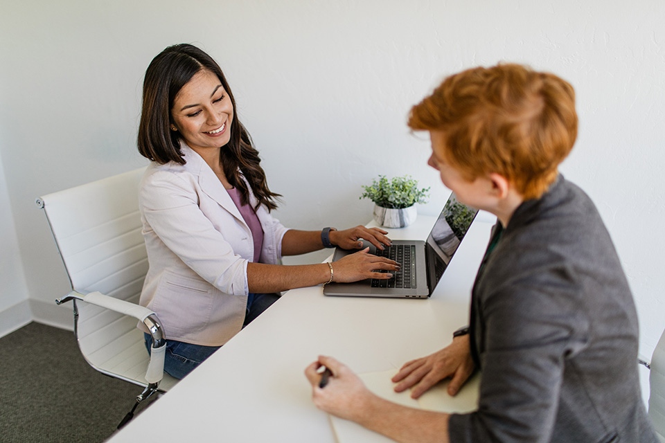 ONE Member Benefits Coach Two women meeting at desk