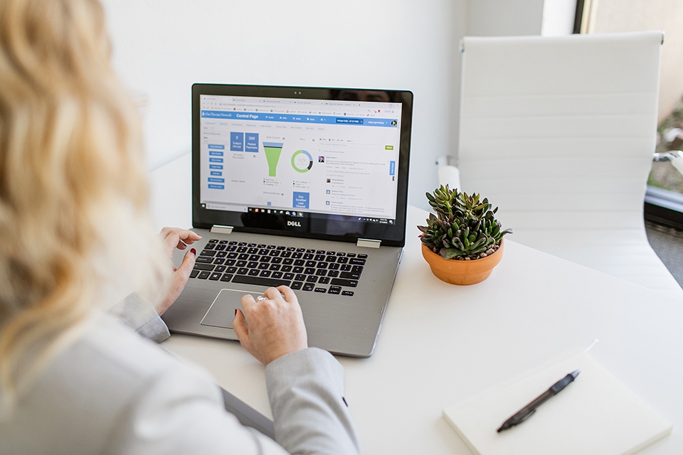 ONE Member Benefits EMR Woman on laptop