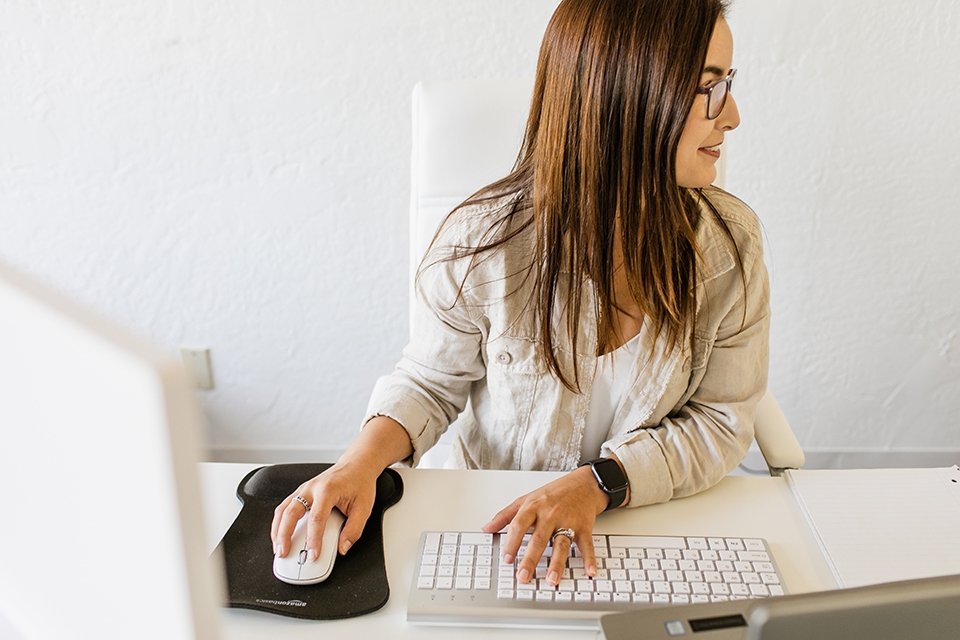 ONE Member Benefits insurance Woman on computer